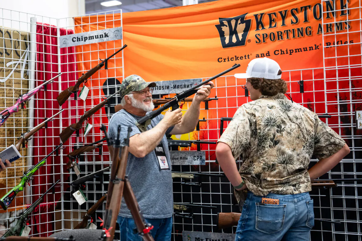 People try firearms at the 2024 National Rifle Association (NRA) exhibits at the Kay Bailey Hutchison Convention Center in Dallas, Texas, on May 17, 2024. (Madalina Vasiliu/The Epoch Times)