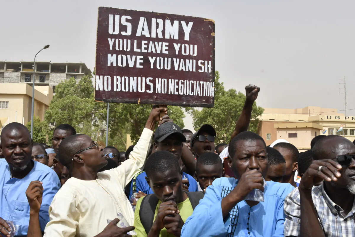 A protester holds up a sign demanding that U.S. soldiers leave Niger during a demonstration in the capital, Niamey, on April 13, 2024. (AFP via Getty Images)