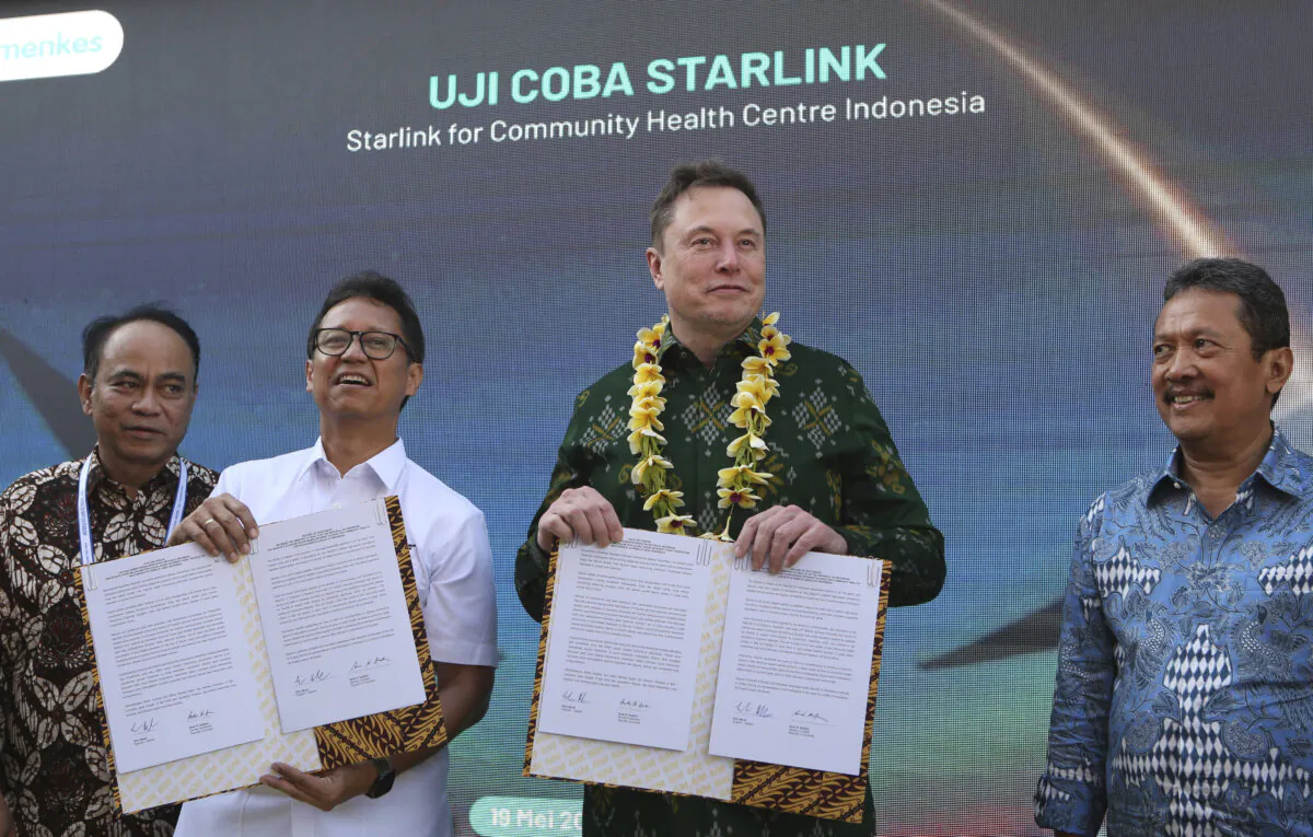Indonesian Minister of Health Budi Gunadi Sadikin (2nd L) and Elon Musk (2nd R) pose after signing an agreement on enhancing connectivity at a public health center in Denpasar, Bali, Indonesia, on May 19, 2024. (Firdia Lisnawati/AP Photo)