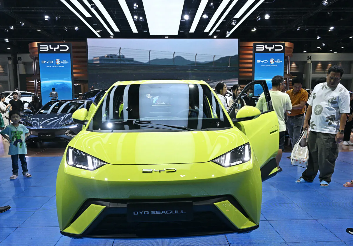 People look at a BYD Seagull car by Chinese electric vehicle manufacturer BYD Auto at the Bangkok International Motor Show in Nonthaburi, Thailand, on March 27, 2024. (Lillian Suwanrumpha/AFP via Getty Images)
