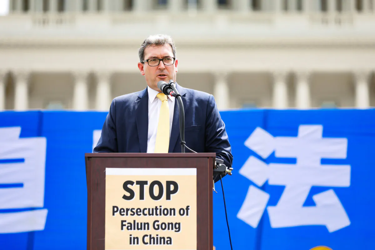 Benedict Rogers, a British human rights activist, speaks at a rally commemorating the 20th anniversary of the persecution of Falun Gong in China, on the West lawn of Capitol Hill in Washington, on July 18, 2019. (Samira Bouaou/The Epoch Times)