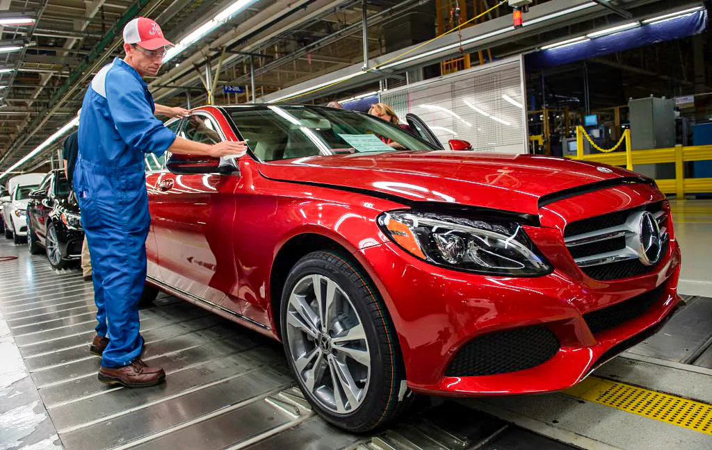 An employee does final inspections on a Mercedes-Benz C-Class at the Mercedes-Benz US International factory in Vance, Alabama on June 8, 2017. (ANDREW CABALLERO-REYNOLDS/AFP/Getty Images)