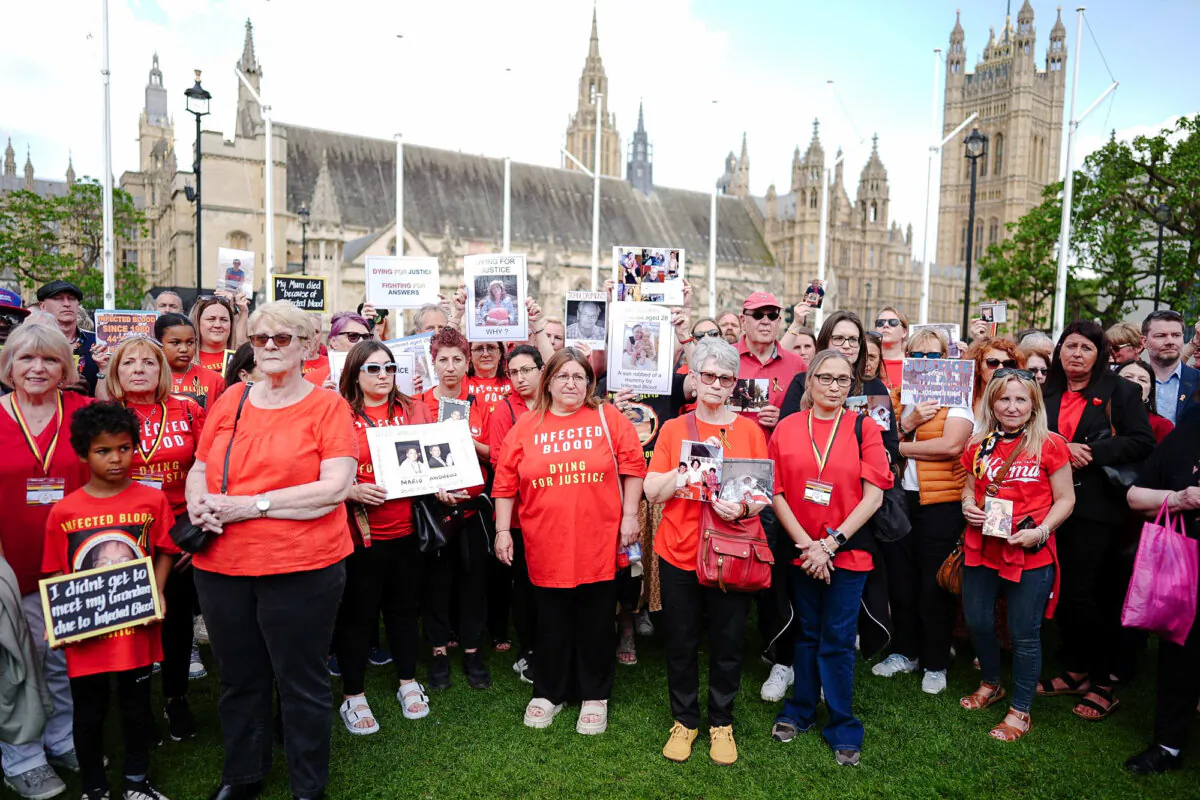 Infected blood campaigners meeting ahead of the publication of the final report into the scandal, in Parliament Square, London, on May 19, 2024. (Aaron Chown/PA Wire)