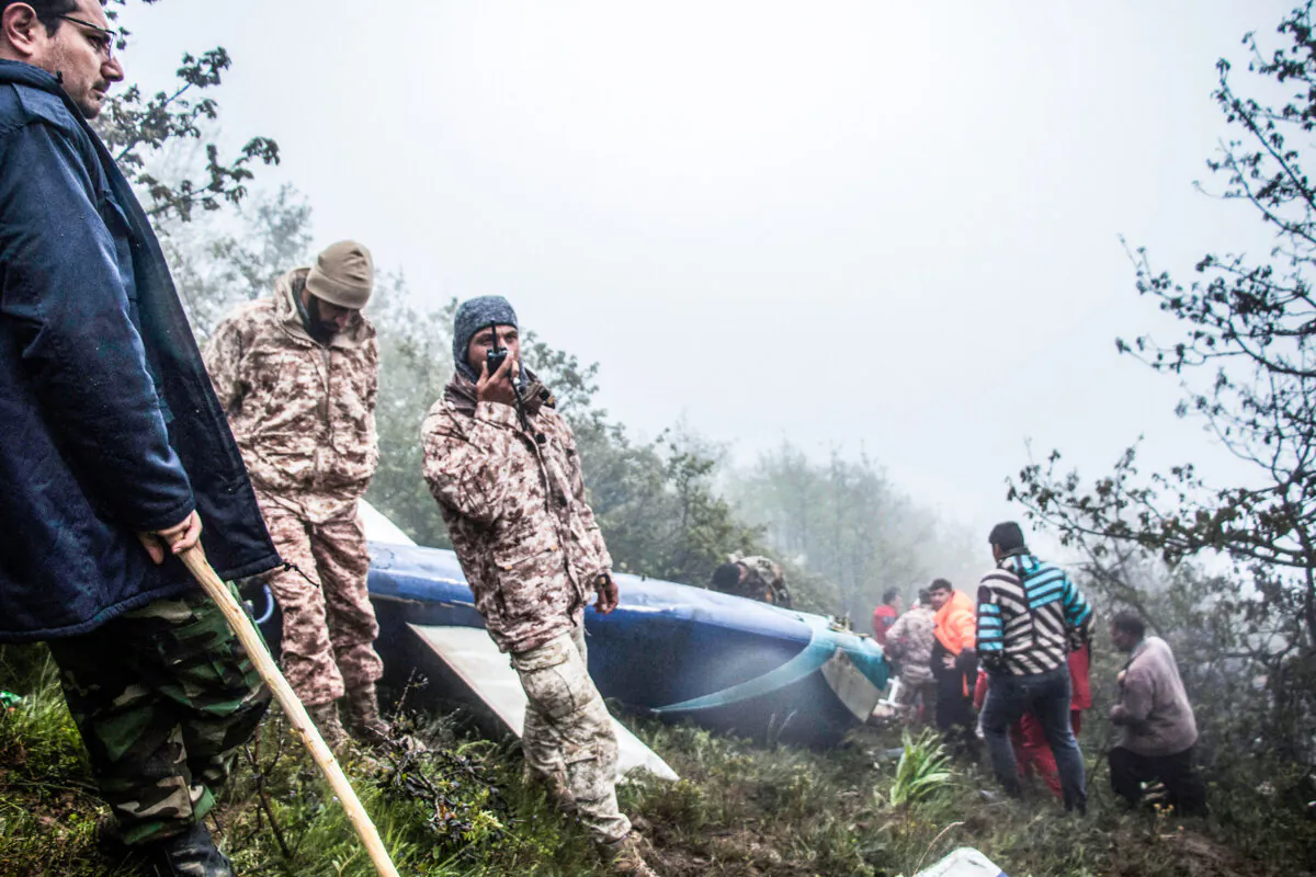 Rescue team members work at the crash site of a crashed helicopter, an incident that killed Iranian President Ebrahim Raisi in Varzaghan, in northwestern Iran, on May 20, 2024. (Azin Haghighi/AFP via Getty Images)