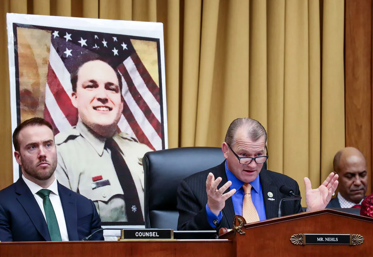 U.S. Rep. Troy Nehls (R-Texas) questions the director of the U.S. Marshals Service about the 2022 assault of Jan. 6 detainee former Sheriff's Deputy Ronald Colton McAbee (in wall photo) during a hearing of the House Judiciary Committee on Feb. 14, 2024. (Emily Matthews/U.S. Rep. Troy Nehls)
