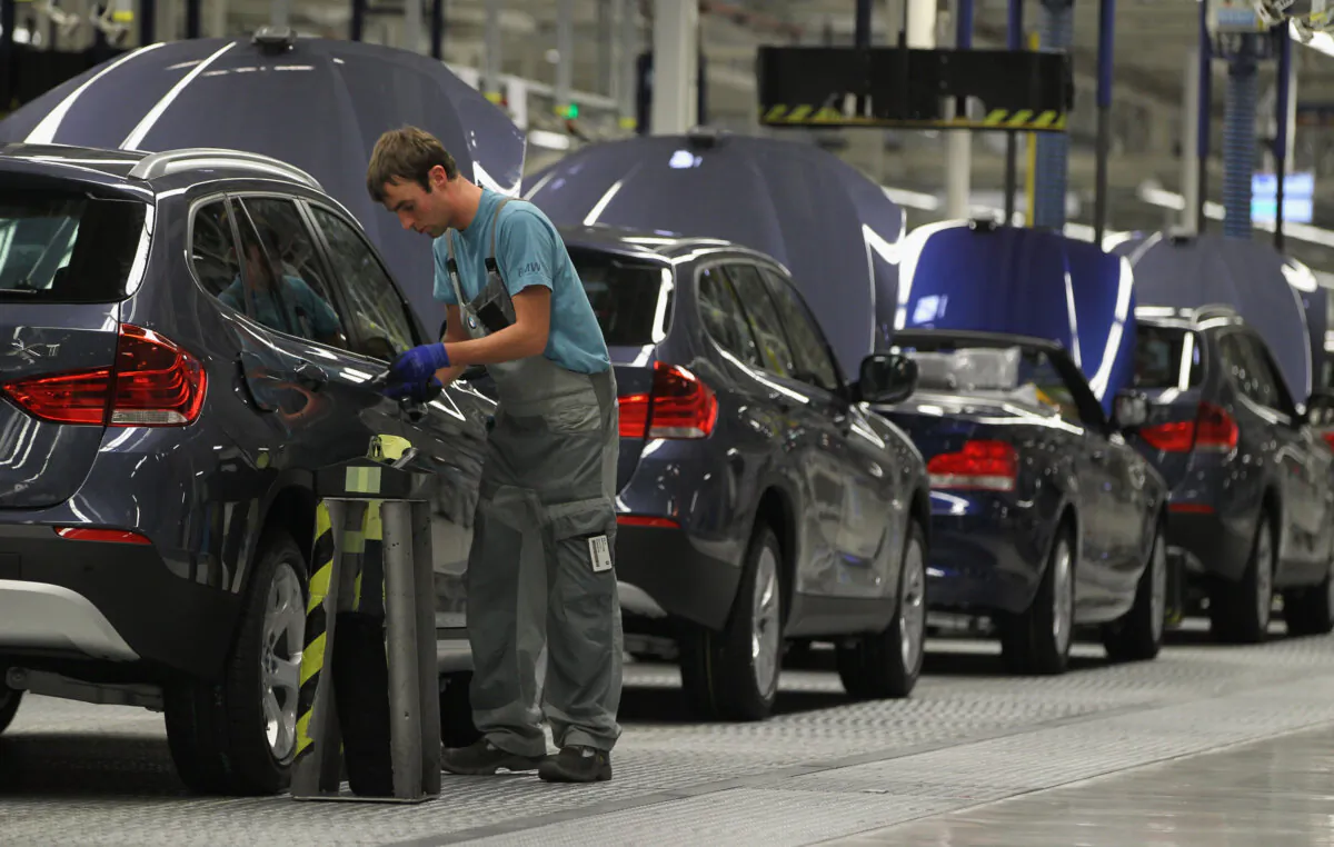 Workers assemble BMW cars at the BMW auto assembly plant in Leipzig, Germany, on November 5, 2010. (Sean Gallup/Getty Images)