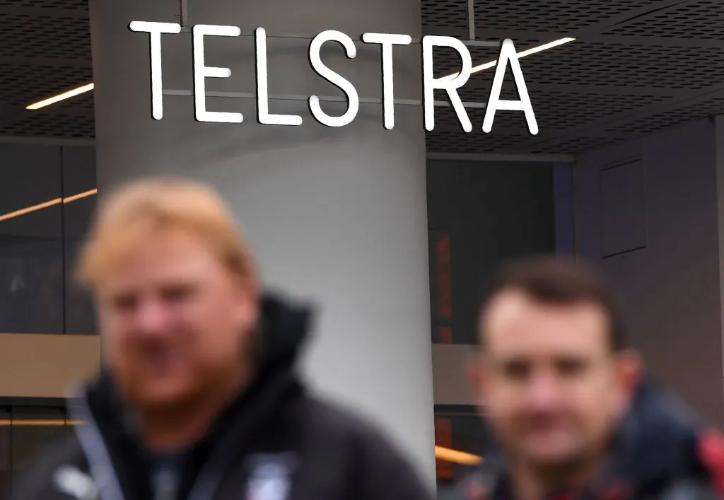 People walk past a Telstra store on Melbourne's central business district on June 20, 2018. (William West/AFP via Getty Images)