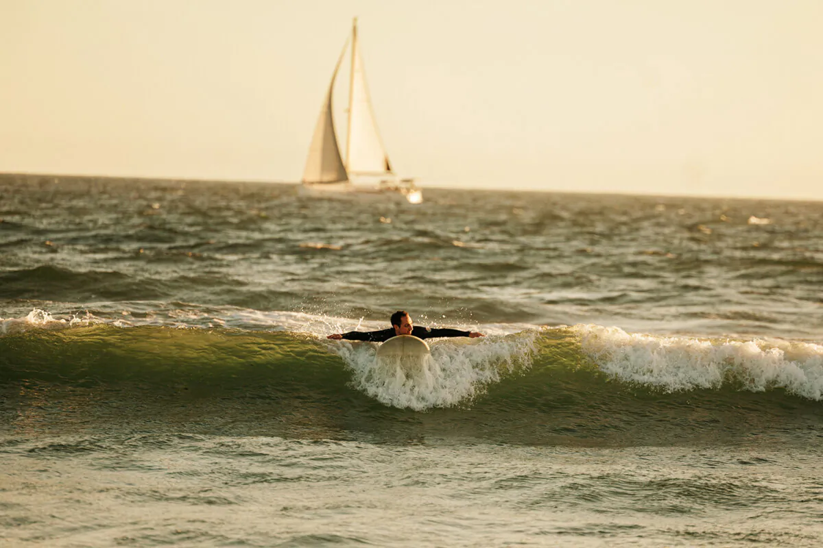 A man surfs at Venice Beach on Wednesday, April 3, 2024 in Venice, CA. (Jason Armond / Los Angeles Times)