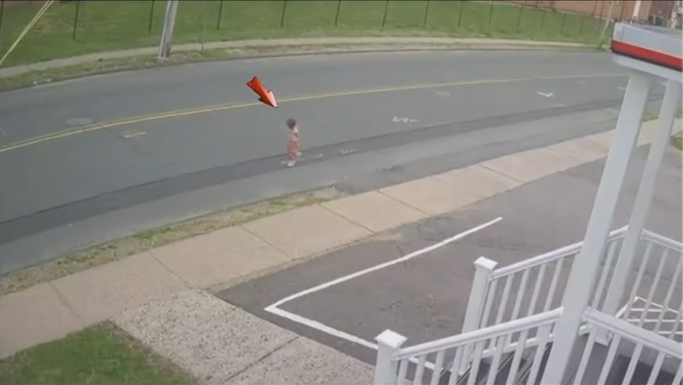 Toddler running toward the traffic on the main street.