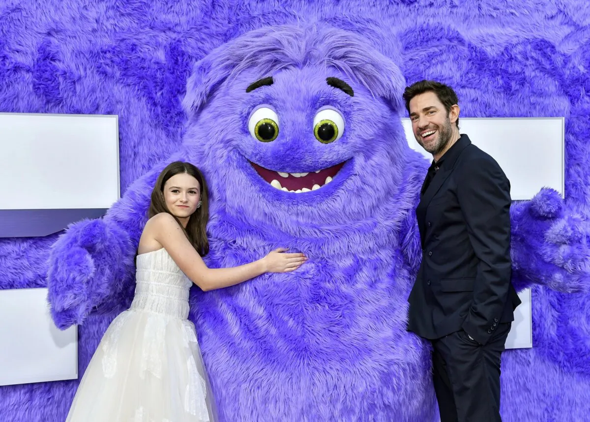 Cailey Fleming (L) and John Krasinski pose with the character "Blue" at the premiere of Paramount Pictures' "IF" at the SVA Theatre in New York, on May 13, 2024. (Evan Agostini/Invision/AP)