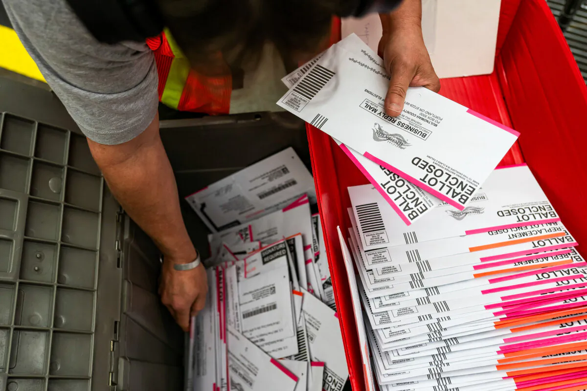 An election worker sorts submitted ballots in a file photo. (Nathan Howard/Getty Images)