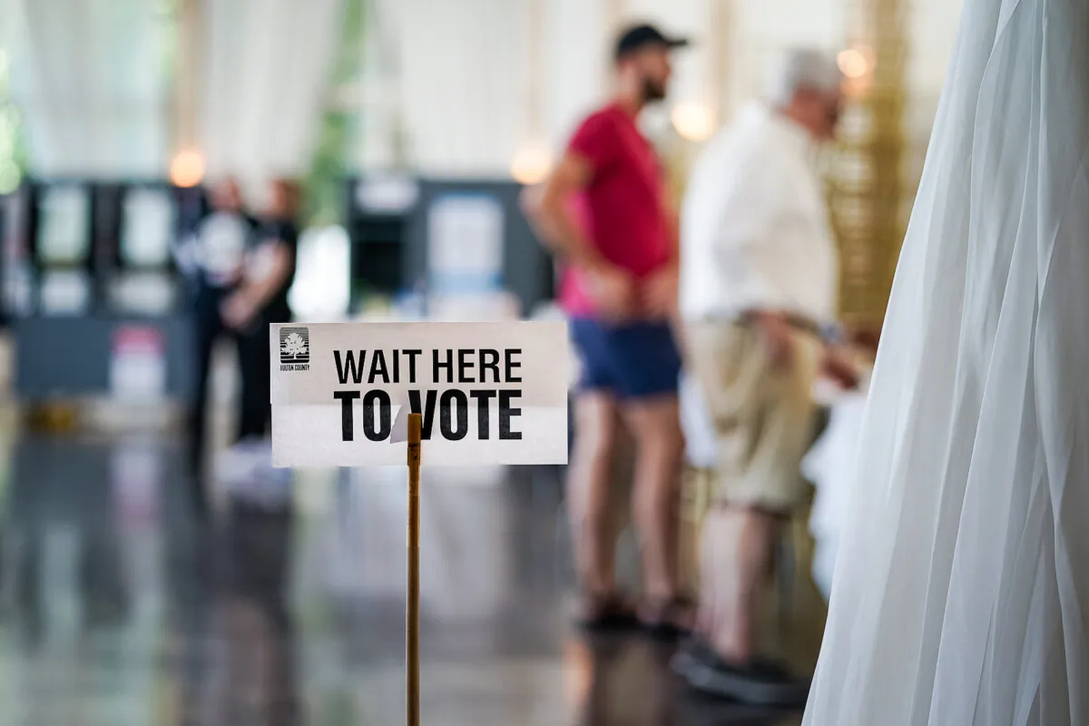 A 'Wait Here To Vote' sign is seen in a polling location as voters check in to cast ballots in Atlanta, Ga., on May 21, 2024. (Elijah Nouvelage/Getty Images)