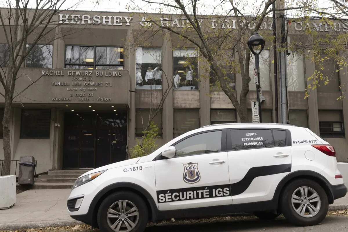 A security vehicle sits outside Yeshiva Gedola, a Jewish school that was hit by gunshots for the second time in three days in Montreal, on Nov. 13, 2023. (The Canadian Press/Christinne Muschi)