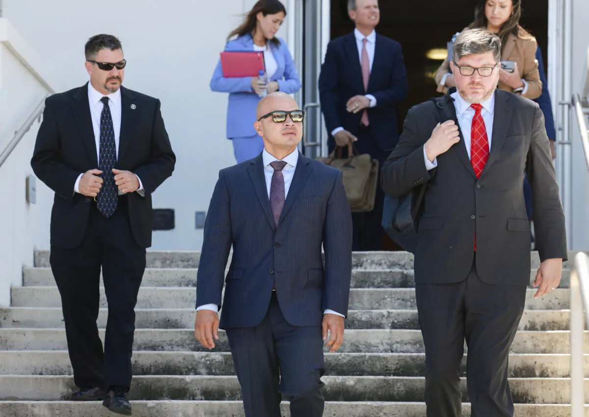 Walt Nauta (Center), an aide to former U.S. President Donald Trump, walks with his lawyer Stanley Woodward (R) as they leave the Alto Lee Adams Sr. U.S. Courthouse in Fort Pierce, Fla., on May 22, 2024. (Joe Raedle/Getty Images)