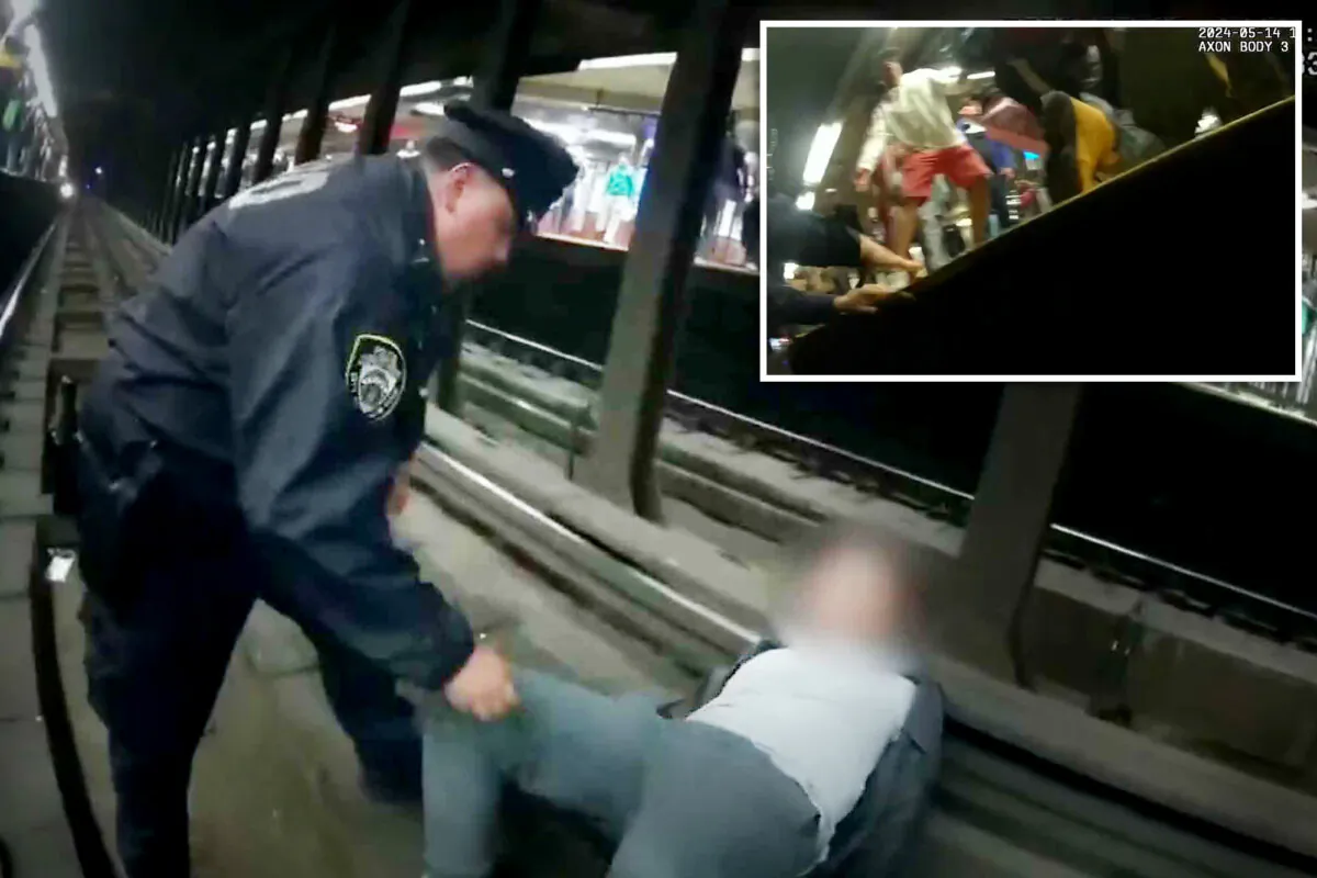 NYPD officers approach a man who fell onto subway tracks in the Bronx on May 14. (Courtesy of NYPD)