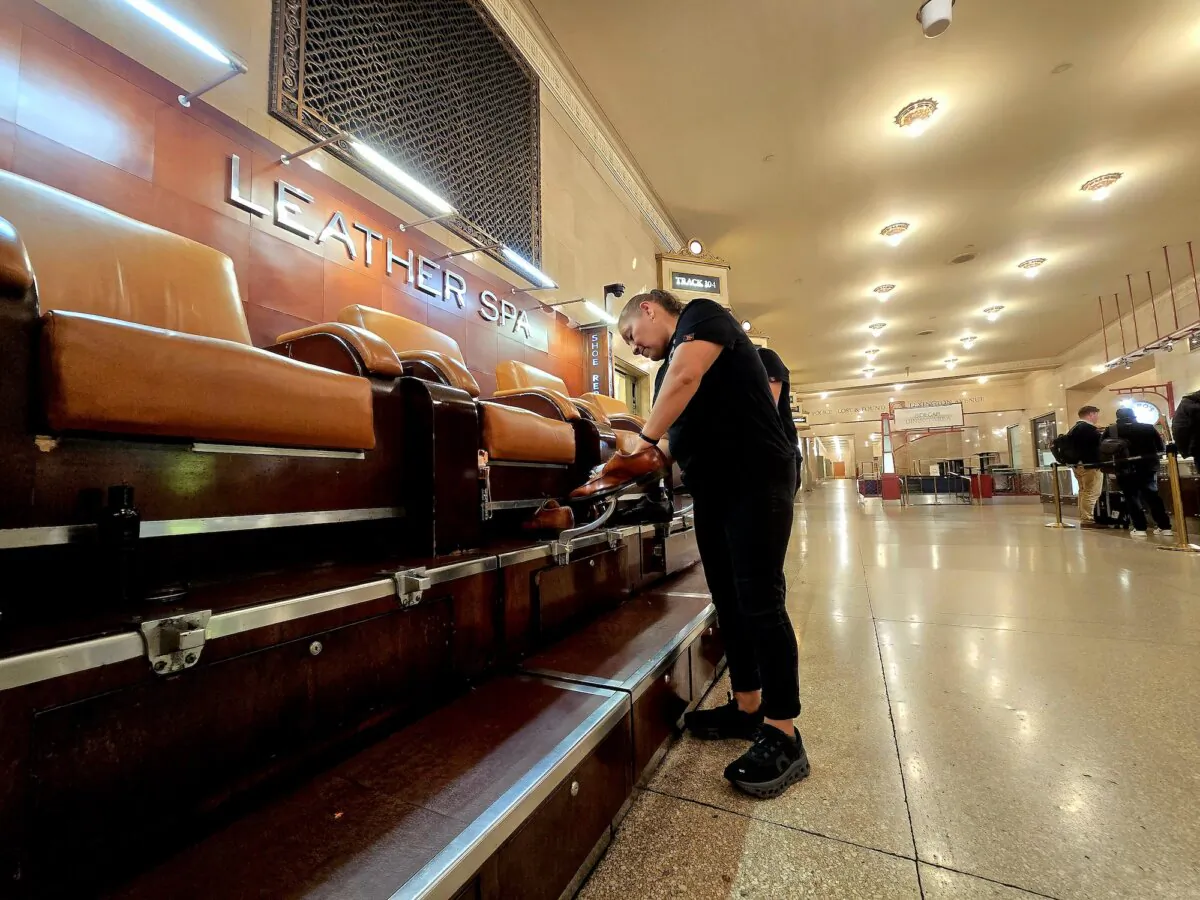 A shoeshiner at Leather Spa at Grand Central Terminal in Midtown Manhattan, N.Y., gets ready for her next customer on May 15, 2024. (Allan Stein/The Epoch Times)