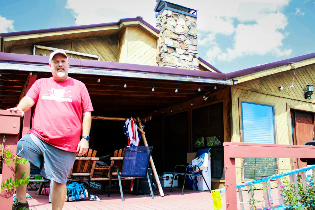 Russell Fincher stands on the porch of his home in Tuskahoma, Okla., on Sept. 1, 2023. (Michael Clements/The Epoch Times)