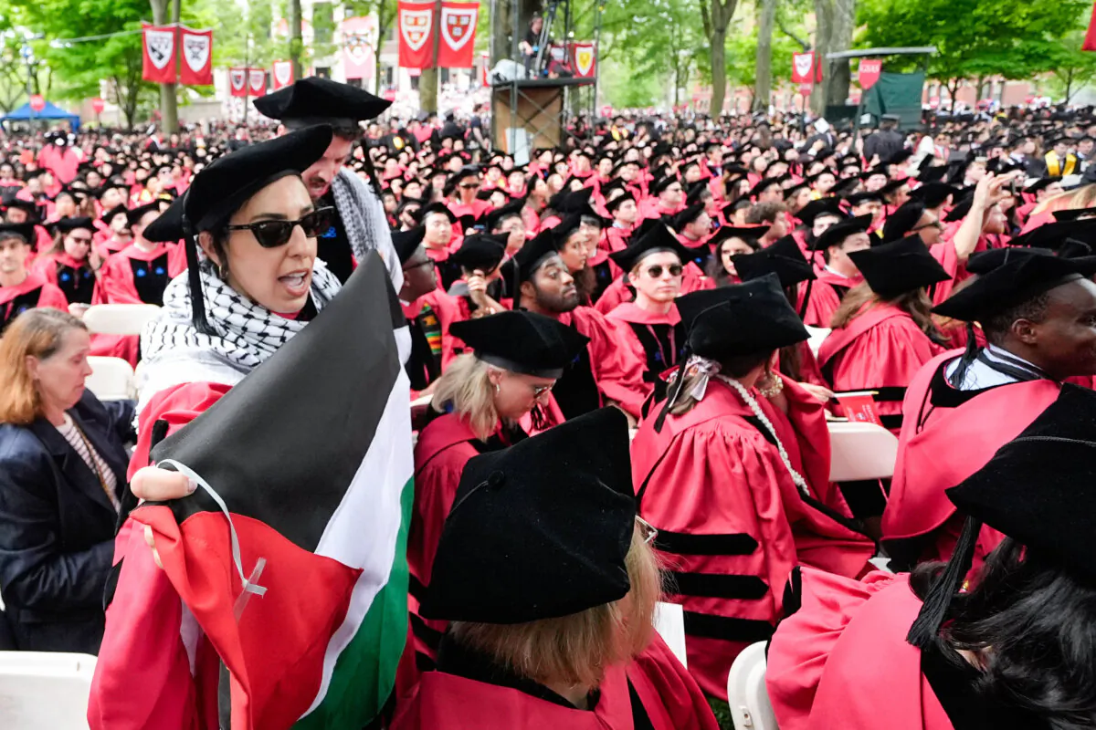 Graduating students chant as they leave their commencement ceremony in solidarity with 13 seniors who were not allowed to participate because of their protest activities at Harvard University in Cambridge, Mass., on May 23, 2024. (Charles Krupa/AP Photo)