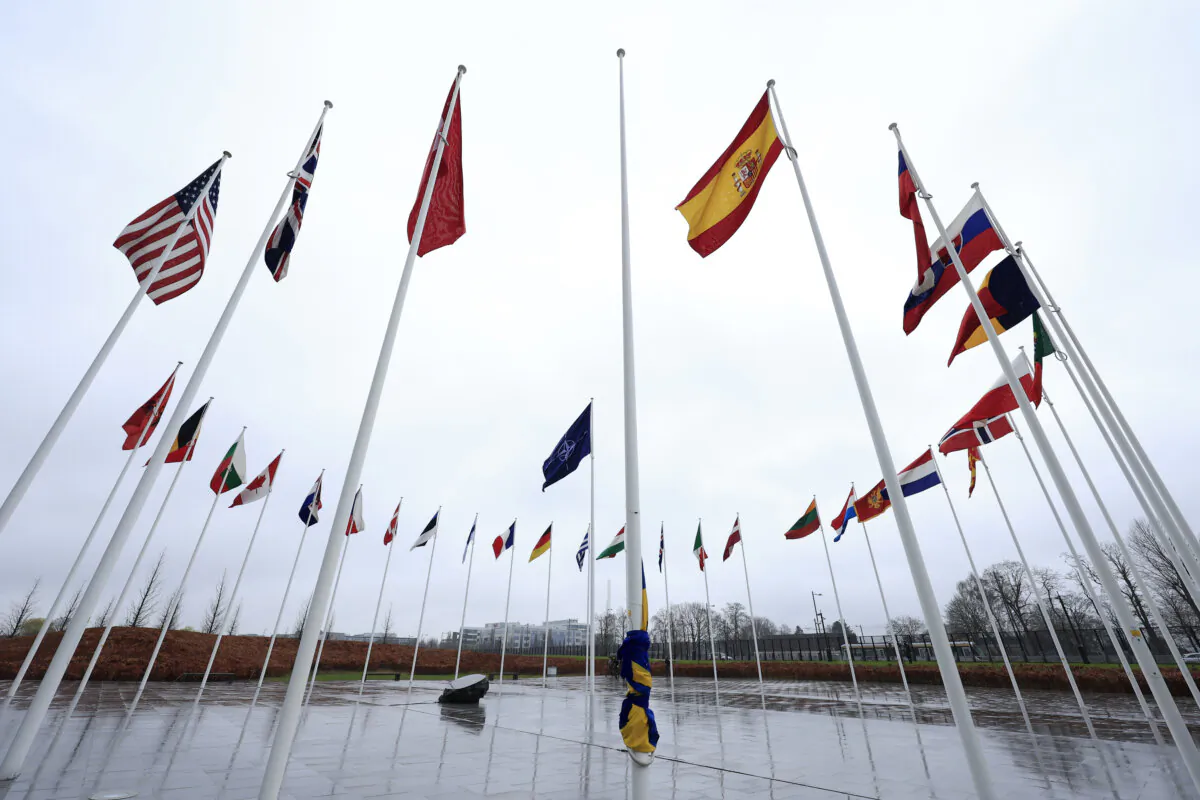 The Swedish flag is tied to a flagpole and surrounded by the flags of other NATO nations, as protocol prepare for a flag raising ceremony to mark the accession of Sweden at NATO headquarters in Brussels, on March 11, 2024. (The Associated Press/Geert Vanden Wijngaert)