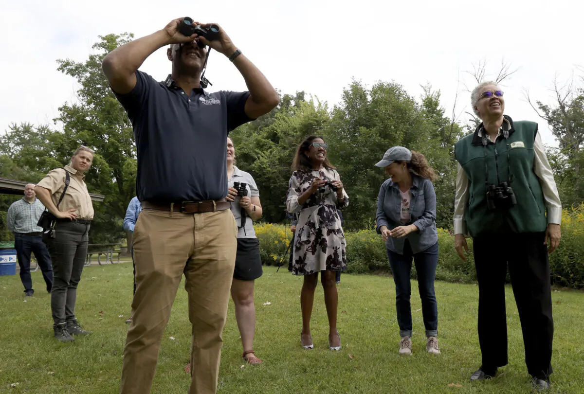 In Illinois, Cook County Board President Toni Preckwinkle, along with officials from the Forest Preserves of Cook County and the Great Lakes Audubon Society, search for birds during a kickoff for the fall bird-watching season at Eggers Grove in Chicago on Sept. 6, 2022. (Antonio Perez/Chicago Tribune/TNS)