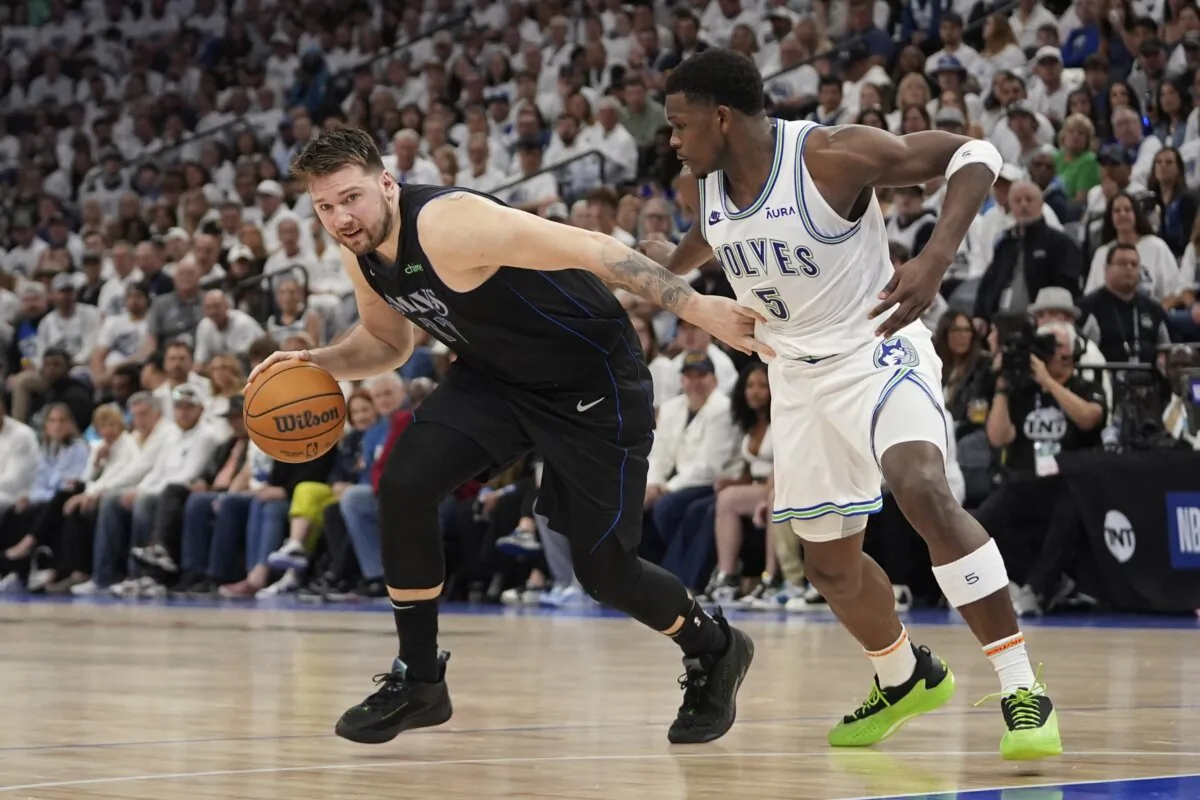 Dallas Mavericks guard Luka Doncic (77) drives against Minnesota Timberwolves guard Anthony Edwards (5) during the first half of Game 2 of the NBA basketball Western Conference finals in Minneapolis on May 24, 2024. (Abbie Parr/AP Photo)
