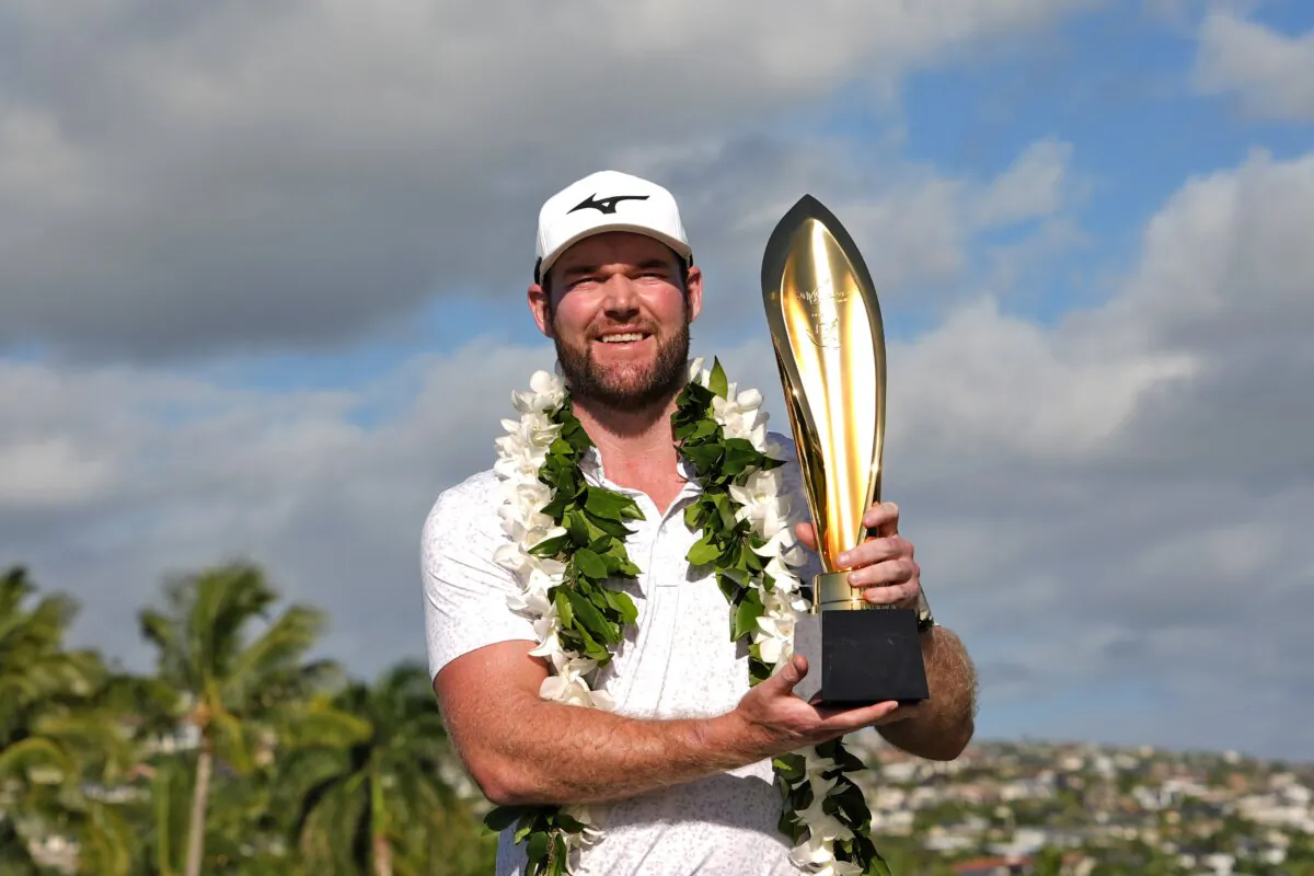 Grayson Murray holds the trophy after winning the Sony Open golf event at Waialae Country Club in Honolulu on Jan. 14, 2024. (Matt York/AP Photo)