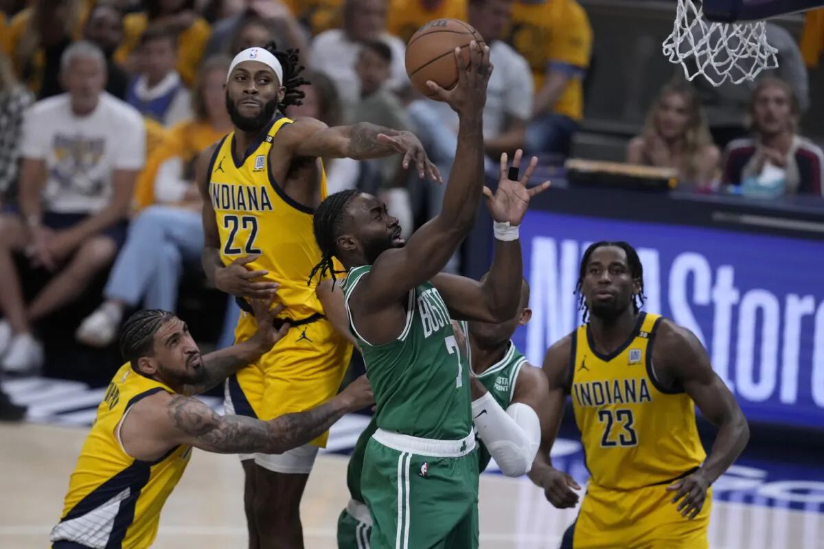 Boston Celtics guard Jaylen Brown (7) drives to the basket between Indiana Pacers forward Obi Toppin (L) forward Isaiah Jackson (22) and forward Aaron Nesmith (23) during the first half of Game 3 of the NBA Eastern Conference basketball finals in Indianapolis on May 25, 2024. (Darron Cummings/AP Photo)