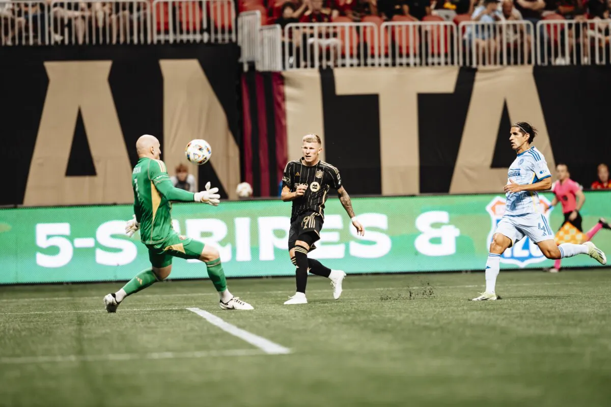 Los Angeles FC
midfielder Mateusz Bogusz (19) shoots past Atlanta United goalkeeper Brad Guzan (1) during a soccer match in Atlanta on May 25, 2024. (Courtesy of Los Angeles FC via The Epoch Times)