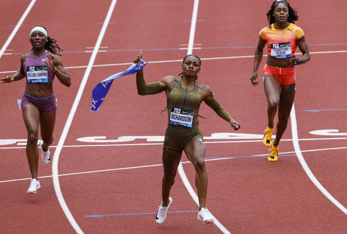 Sha'Carri Richardson holds a piece of the tape after winning the women's 100 meters at the Prefontaine Classic track and field meet in Eugene, Ore., on May 25, 2024. (Thomas Boyd/AP Photo)