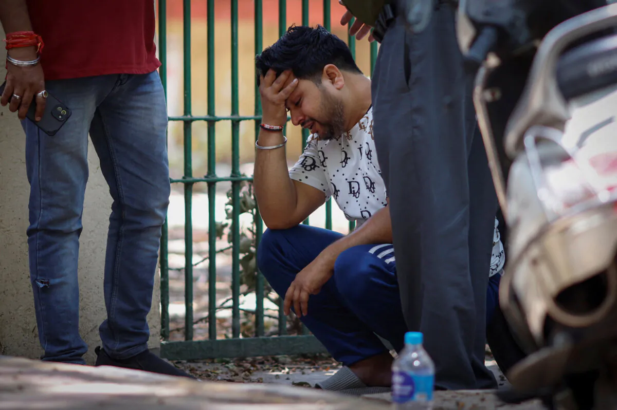 Vinod Kumar cries outside a hospital morgue after his newborn child went missing following a fire at a baby care hospital, in New Delhi, India, on May 26, 2024. (Adnan Abidi/Reuters)