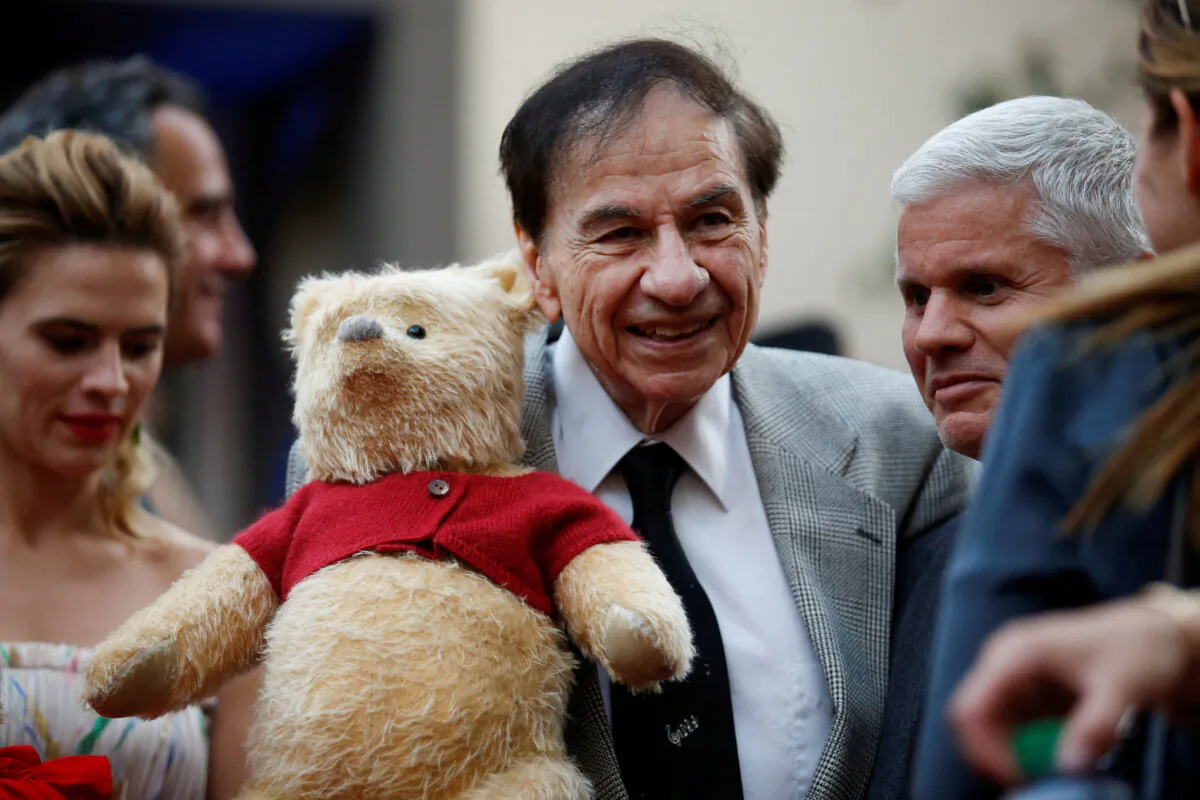 Songwriter Richard M. Sherman holds a stuffed Winnie the Pooh as he poses at the world premiere of Disney's "Christopher Robin," in Burbank, Calif., on July 30, 2018. (Danny Moloshok/Reuters)