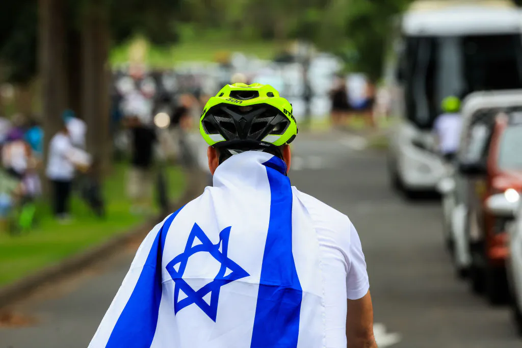 A cyclist wearing the flag of Israel is seen during an art exhibition and demonstration at Centennial Park in Sydney, Australia, on Jan. 14, 2024. (Jenny Evans/Getty Images)