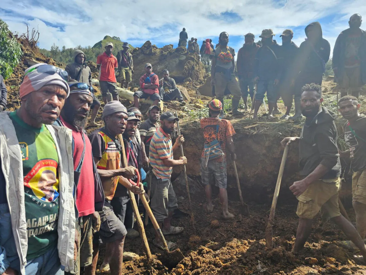 Locals gather amid the damage after a landslide in Maip Mulitaka, Enga province, Papua New Guinea in this obtained image on May 24, 2024. (Emmanuel Eralia via Reuters)
