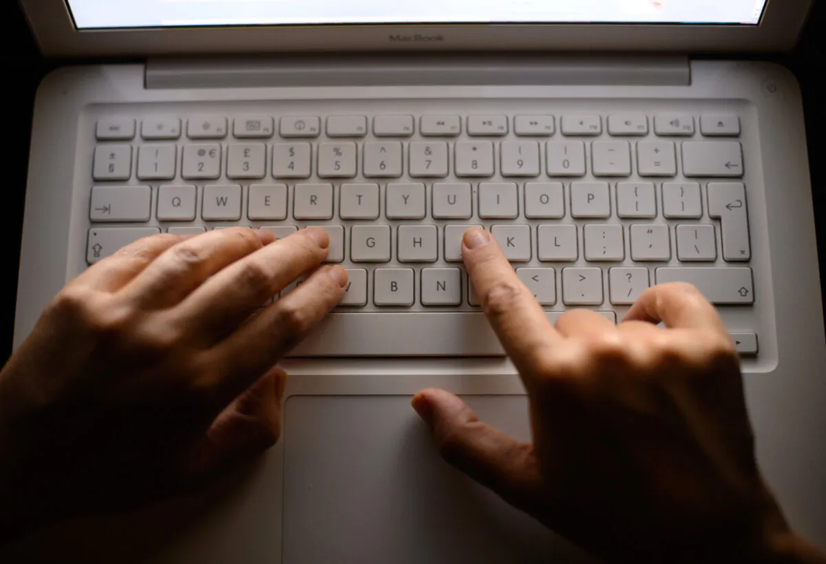 A woman's hands using a laptop keyboard on Aug. 16, 2013. (Dominic Lipinski/PA Wire)
