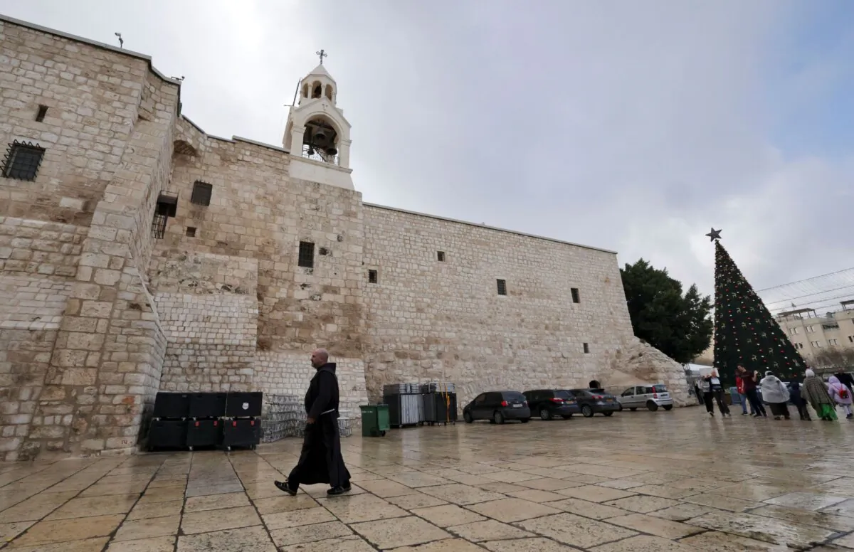 A Christian monk walks outside the Church of the Nativity in the West Bank city of Bethlehem ahead of Christmas on Dec. 22, 2022. (Hazem Bader/AFP via Getty Images)