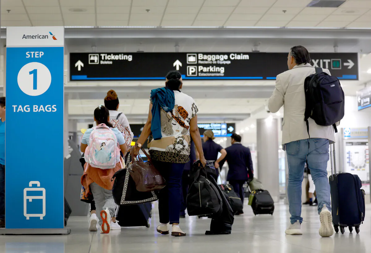 Travelers make their way through the Miami International Airport in Miami, Fla., on May 24, 2024. (Joe Raedle/Getty Images)