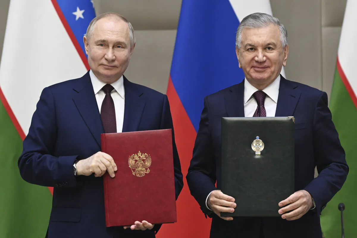 Russian President Vladimir Putin, left, and Uzbek President Shavkat Mirziyoyev attend a signing ceremony following a meeting in expanded format at the Kuksaroy Presidential Palace in Tashkent, Uzbekistan, Monday, May 27, 2024. (Sergei Bobylev, Sputnik, Kremlin Pool Photo via AP)
