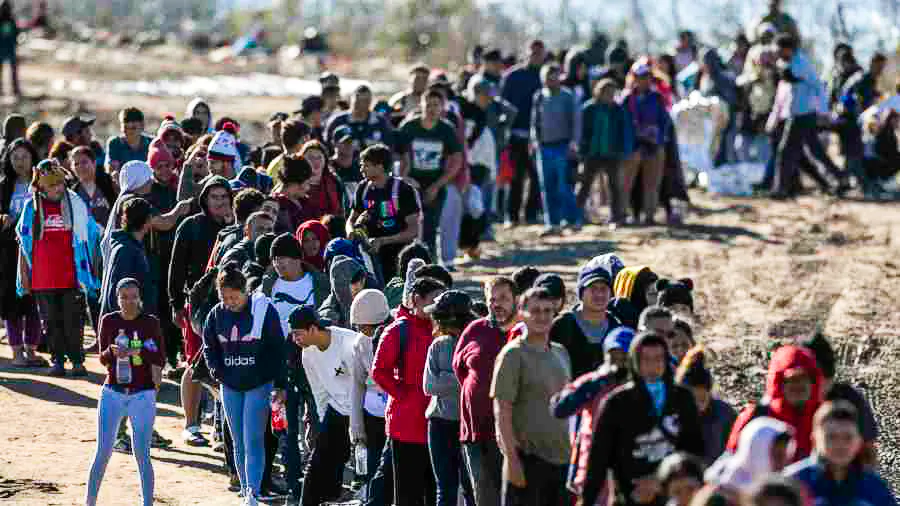 More than 1,000 illegal immigrants line up to be processed by U.S. Border Patrol agents after crossing the Rio Grande from Mexico in Eagle Pass, Texas, on Dec. 18, 2023. (John Moore/Getty Images)
