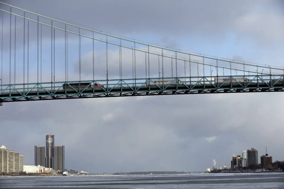 Traffic crosses the Ambassador Bridge from Detroit, Michigan, (L) into Windsor, Ontario, in a file photo. (AP Photo/Carlos Osorio)