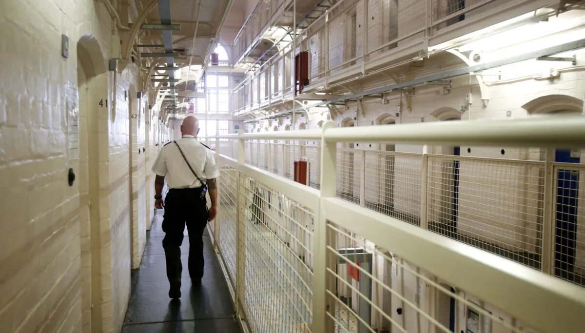A prison officer walks down the landing at Barlinnie prison in Glasgow, Scotland, on Oct. 16, 2013. (Danny Lawson/PA)