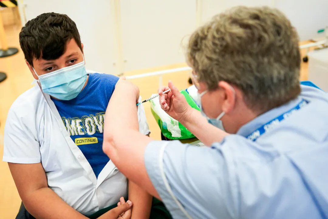 A boy receives the Pfizer-BioNTech COVID-19 vaccine in Newcastle upon Tyne, England, on Sept. 22, 2021. (Ian Forsyth/Getty Images)