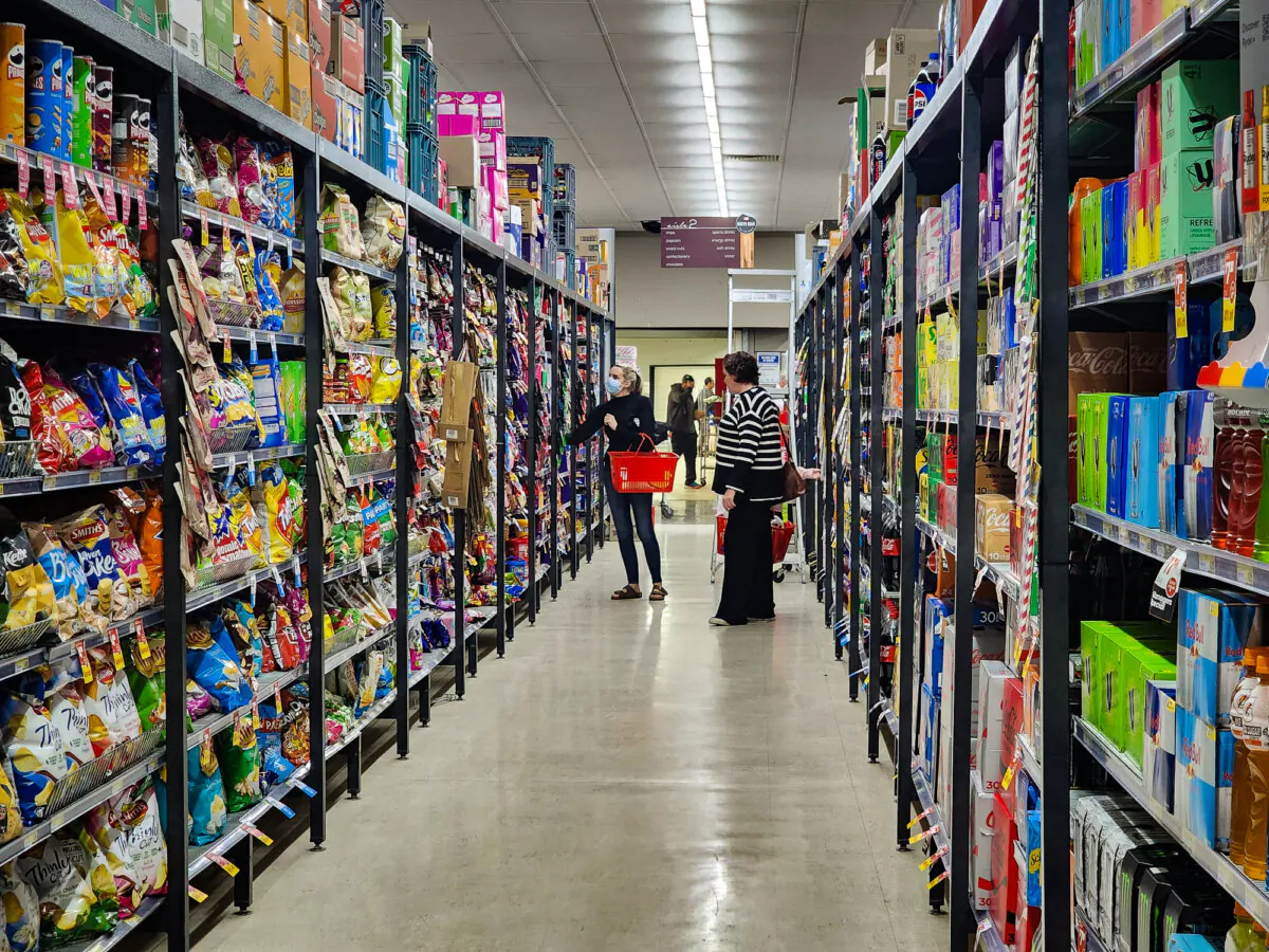 People shop in the confectionery section of a supermarket in Western Australia on May 4, 2024. (Susan Mortimer/The Epoch Times)
