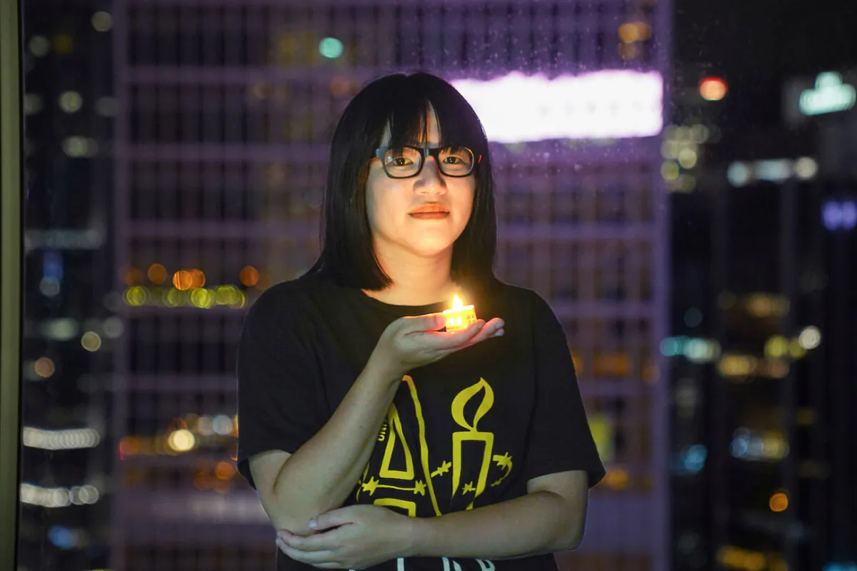Vice-chairwoman of Hong Kong Alliance in Support of Patriotic Democratic Movements of China, Chow Hang Tung, poses with a candle ahead of the 32nd anniversary of the massacre of pro-democracy demonstrators at Beijing's Tiananmen Square in 1989, in Hong Kong, on June 3, 2021. (Lam Yik/Reuters)