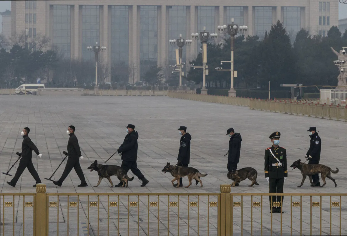 The Chinese police canine and explosives unit do a security sweep in Tiananmen Square before the closing session of the Chinese People's Political Consultative Conference (CPPCC) at the Great Hall of the People on March 10, 2022 in Beijing, China. (Kevin Frayer/Getty Images)
