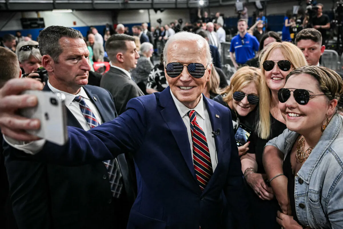 President Joe Biden takes a selfie with supporters at a YMCA in Nashua, N.H., on May 21, 2024. (Mandel Ngan/AFP via Getty Images)