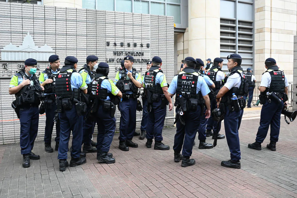 Policemen are seen outside the West Kowloon Magistrates' Court in Hong Kong on May 30, 2024, which found 14 people guilty of subversion in the biggest case against pro-democracy campaigners since China imposed a national security law to crush dissent. (PETER PARKS/AFP via Getty Images)
