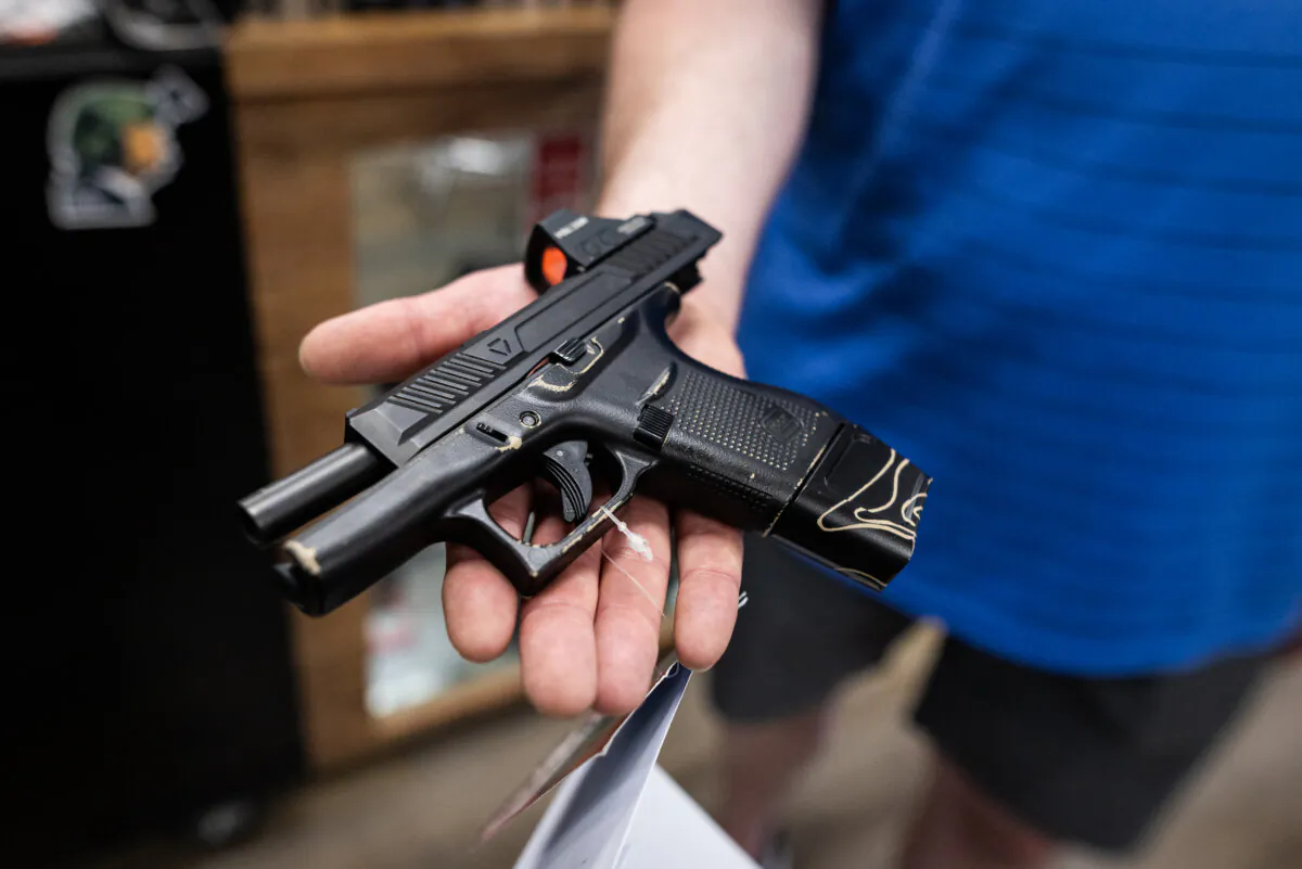 Customers shop for firearms in San Diego, Calif., on May 30, 2024. (John Fredricks/The Epoch Times)