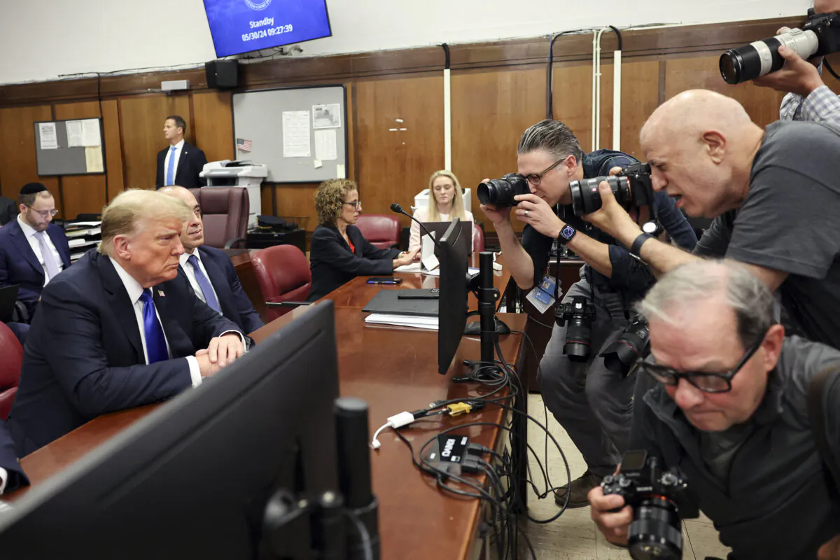 Photojournalists take pictures as former President and Republican presidential candidate Donald Trump attends his criminal trial at Manhattan Criminal Court in New York City, on May 30, 2024. (Michael M. Santiago/Pool/AFP via Getty Images)