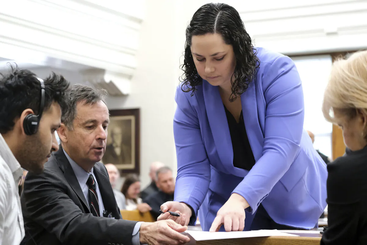 Defense attorneys Kaitlyn Beck and John Donnelly present the not guilty plea for Jose Ibarra to sign during Ibarra's court appearance, in Athens, Ga., on May 31, 2024. (Nell Carroll/Atlanta Journal-Constitution via AP, Pool)