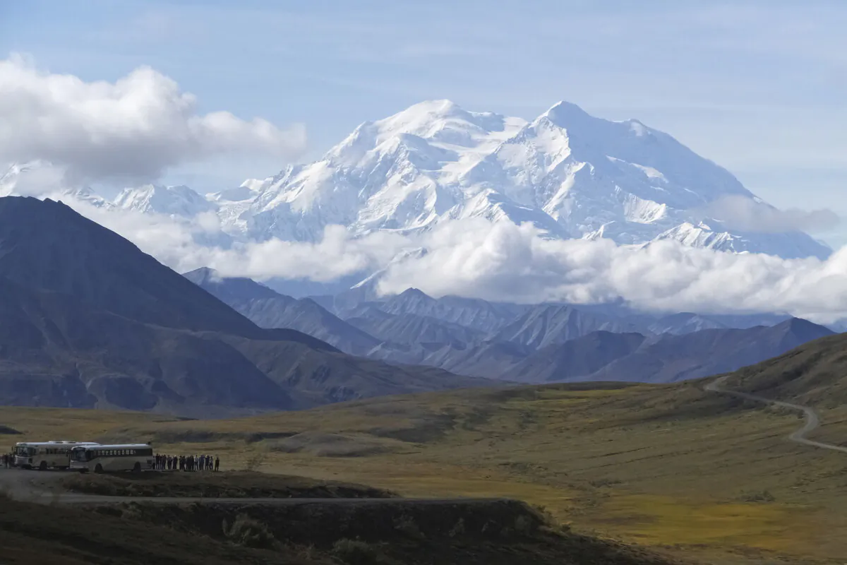 Sightseeing buses and tourists are seen at a pullout popular for taking in views of North America's tallest peak, Denali, in Denali National Park and Preserve, Alaska, on Aug. 26, 2016. (Becky Bohrer/AP Photo)